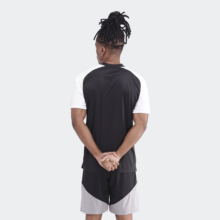 Men's Orlando Pirates 26 Pre Match Trefoil Jersey in black and white, worn by a model facing away, showcasing the back.