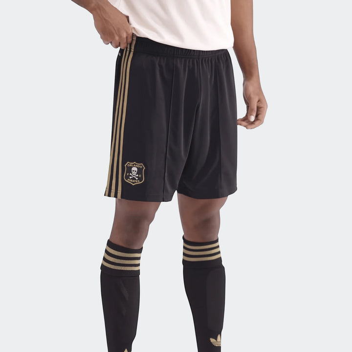 Orlando Pirates black football shorts with gold side stripes, elastic waistband and team crest.