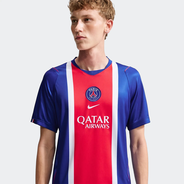 Front view of a male model wearing a blue, red, and white Paris Saint-Germain 2026/27 Stadium Home Nike Dri-Fit Soccer