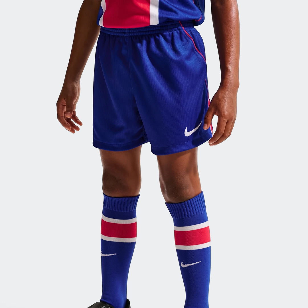 Close-up of a child wearing a Paris Saint-Germain 2026 Stadium Home Little Kids' Nike Soccer Replica Kit, featuring blue