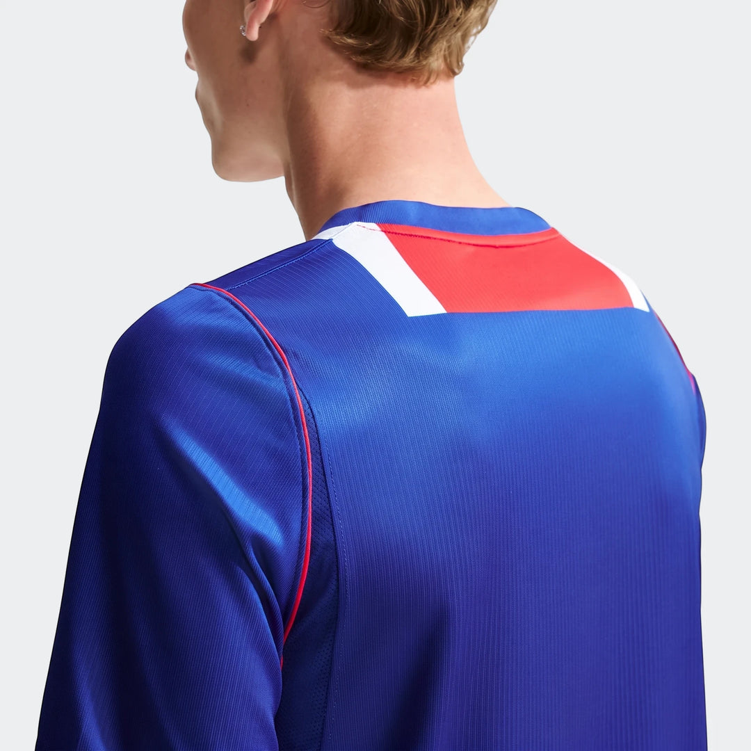 Back view of a man wearing a blue Paris Saint-Germain 2026/27 Stadium Home Men's Nike Dri-Fit Soccer Replica Jersey.
