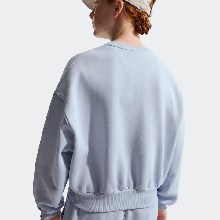 Rear view of a person wearing a light blue G Nsw Club Fleece Boxy Crewneck sweatshirt and matching sweatpants.