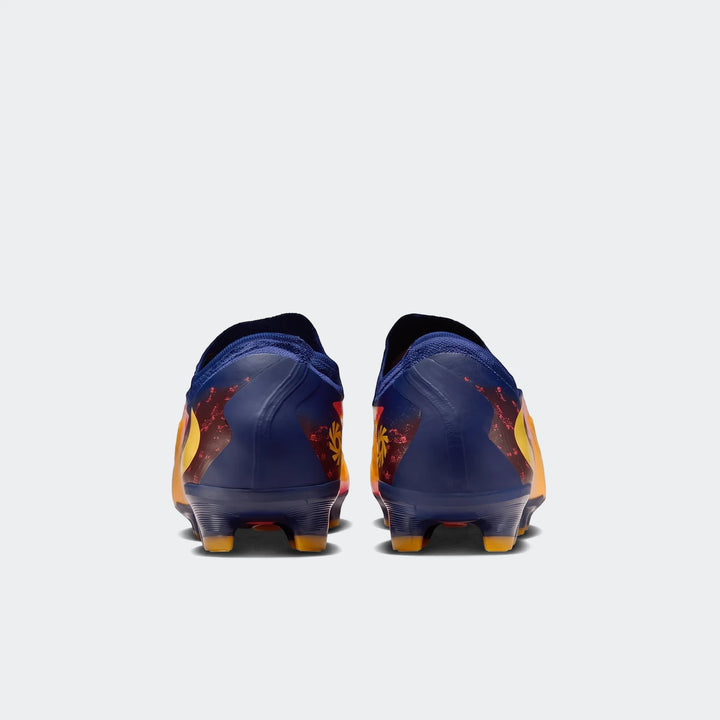 Rear view of Phantom 6 Low Pro Fg Orange Boots, featuring navy blue heels with vibrant red, orange, and yellow abstract