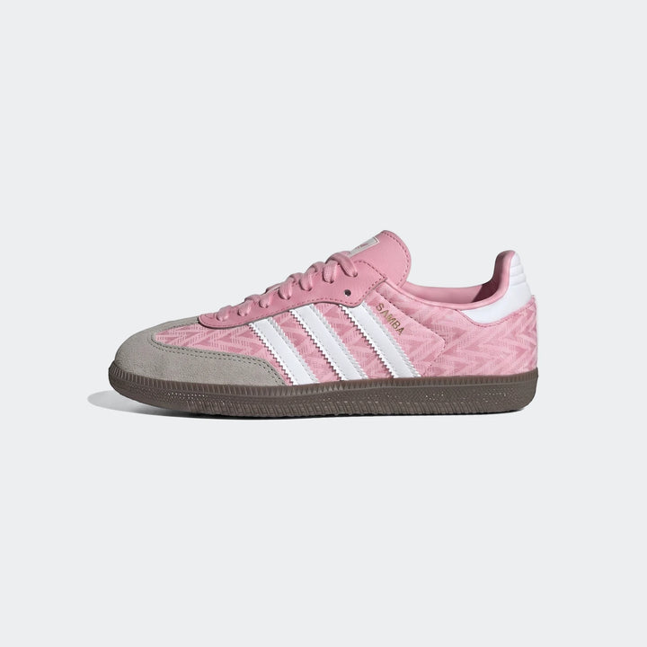 Pink Adidas Samba Og Kids shoe in a left profile view, featuring a patterned textile upper and white stripes.