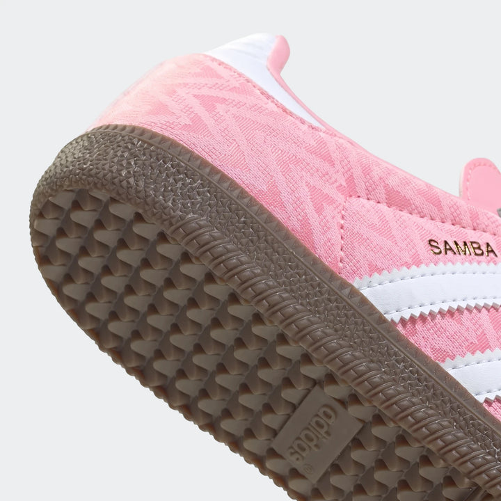 Pink Adidas Samba Og Kids Shoes with white stripes and a brown gum sole, viewed from an angle showing the side and bottom.
