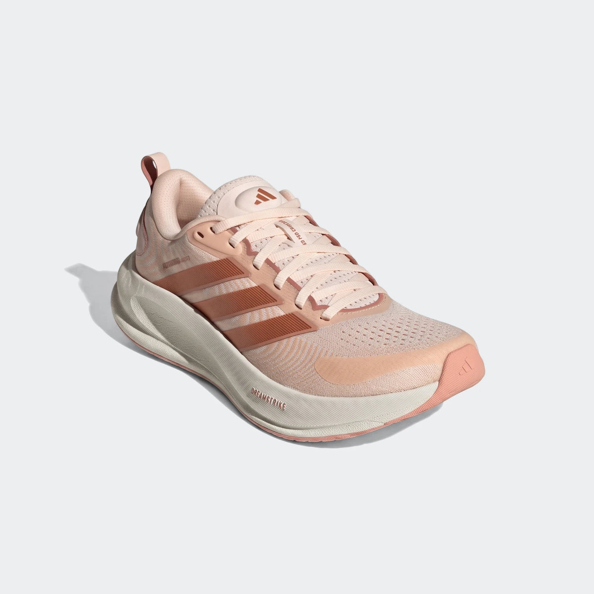 Pink Adidas Supernova Ease 2 running shoe, featuring peach stripes and a textured mesh upper, viewed from a slightly