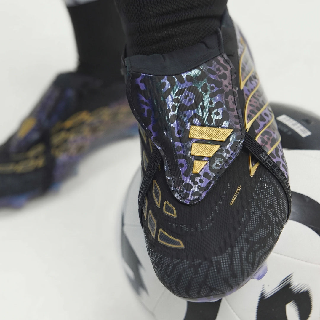 Close-up of black, purple, and gold leopard print Adidas Predator Elite Kaka Edition football boots resting on a soccer ball.