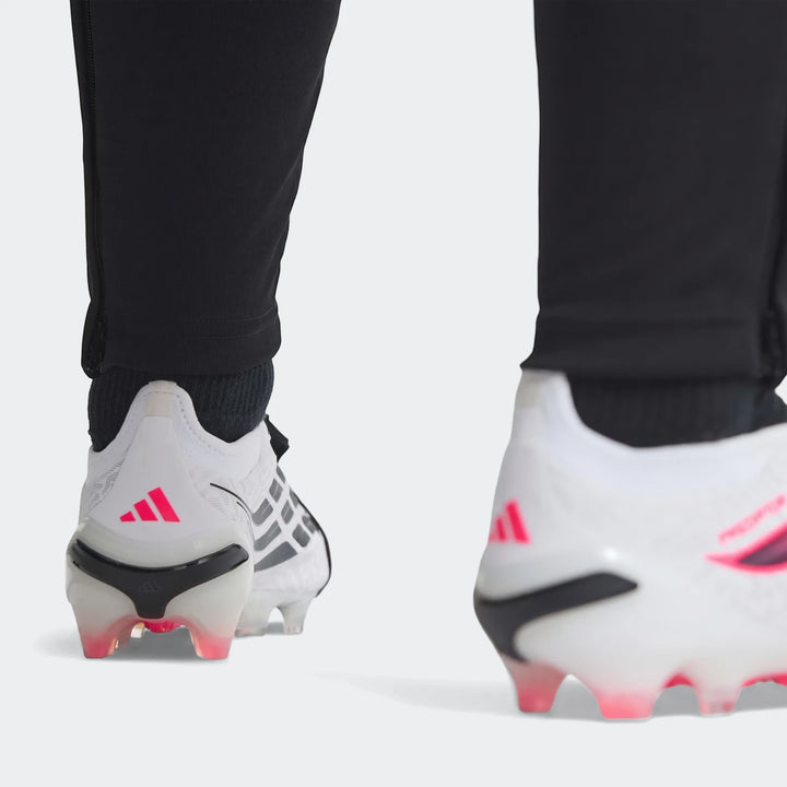 Rear view of white and pink Predator Elite Fold-Over Tongue Firm Ground Football Boots on a player. Adidas logo, pink studs,
