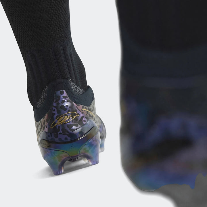 Close-up of a Predator Elite Ft Fg Kaka Edition Football Boot with iridescent sole, black and purple leopard print, and