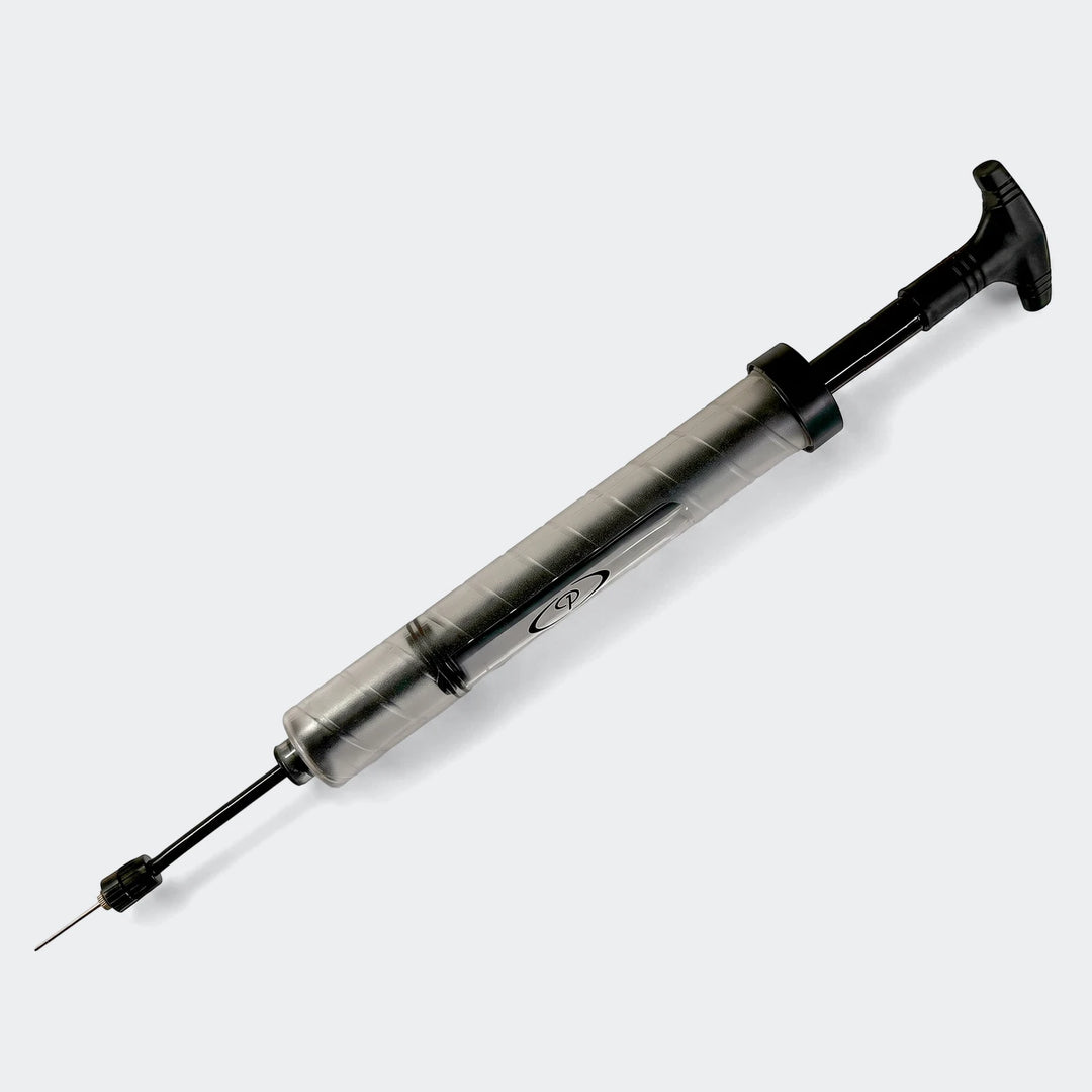 Premier Double Action Pump in black and grey with a metal needle attachment, positioned diagonally against a white