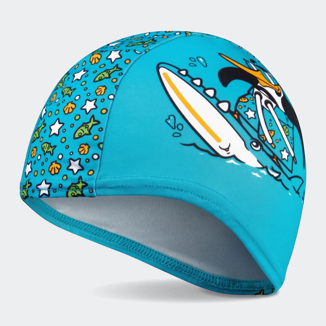 Printed blue polyester swim cap for kids, featuring a fun surfing penguin and marine life pattern.