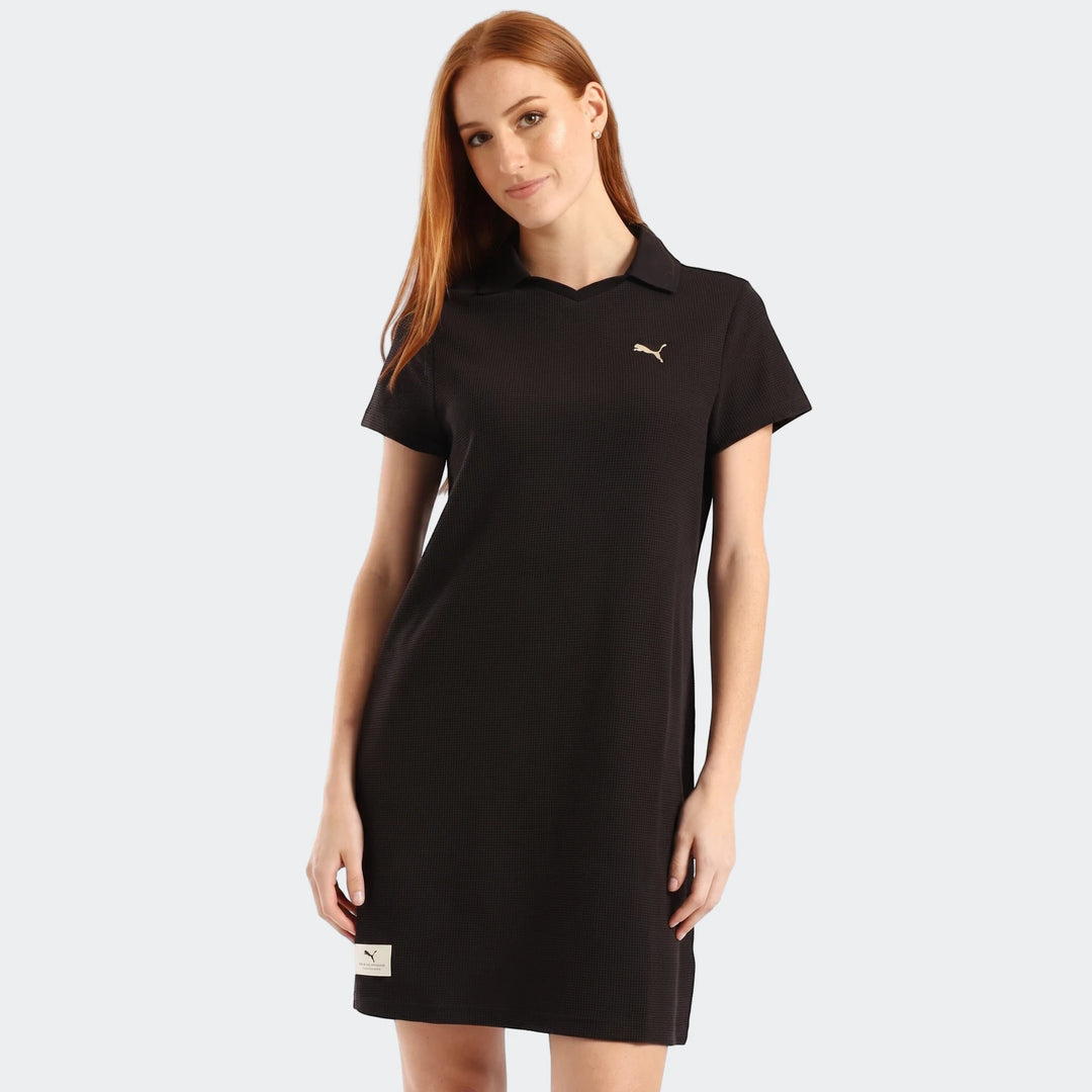 Puma Class Pinnacle Dress in black, worn by a woman, featuring a collared polo style and short sleeves.