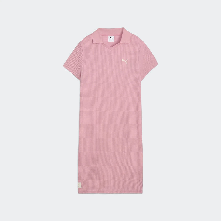 Pink Puma Class Pinnacle Dress for women, featuring a pique texture fabric, V-neck polo collar, and short sleeves, displayed