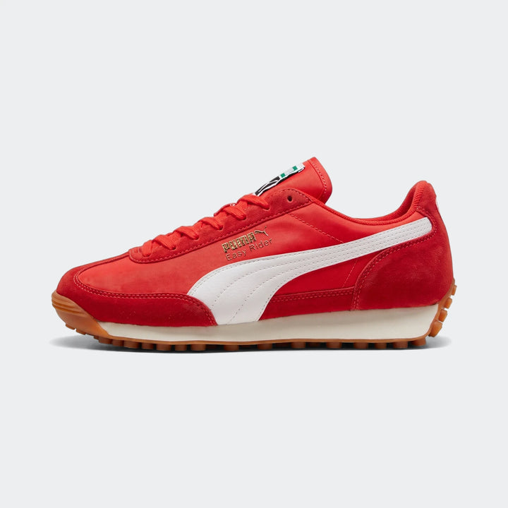 Red Puma Easy Rider Kids PS sneakers in a side profile view, featuring white laces, stripe, and a contrasting brown rubber
