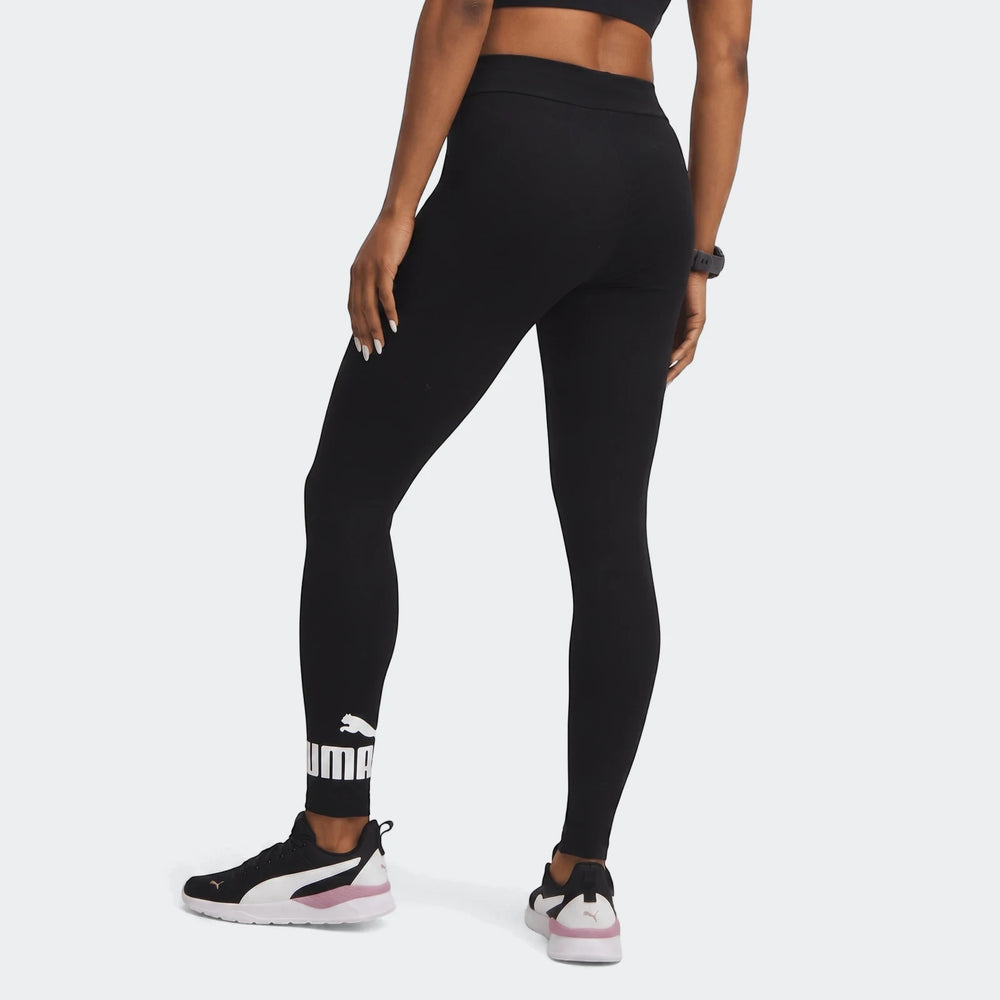 Model wearing black Puma Ess No:1 Logo Leggings, showcasing the back view and logo detail on the ankle.