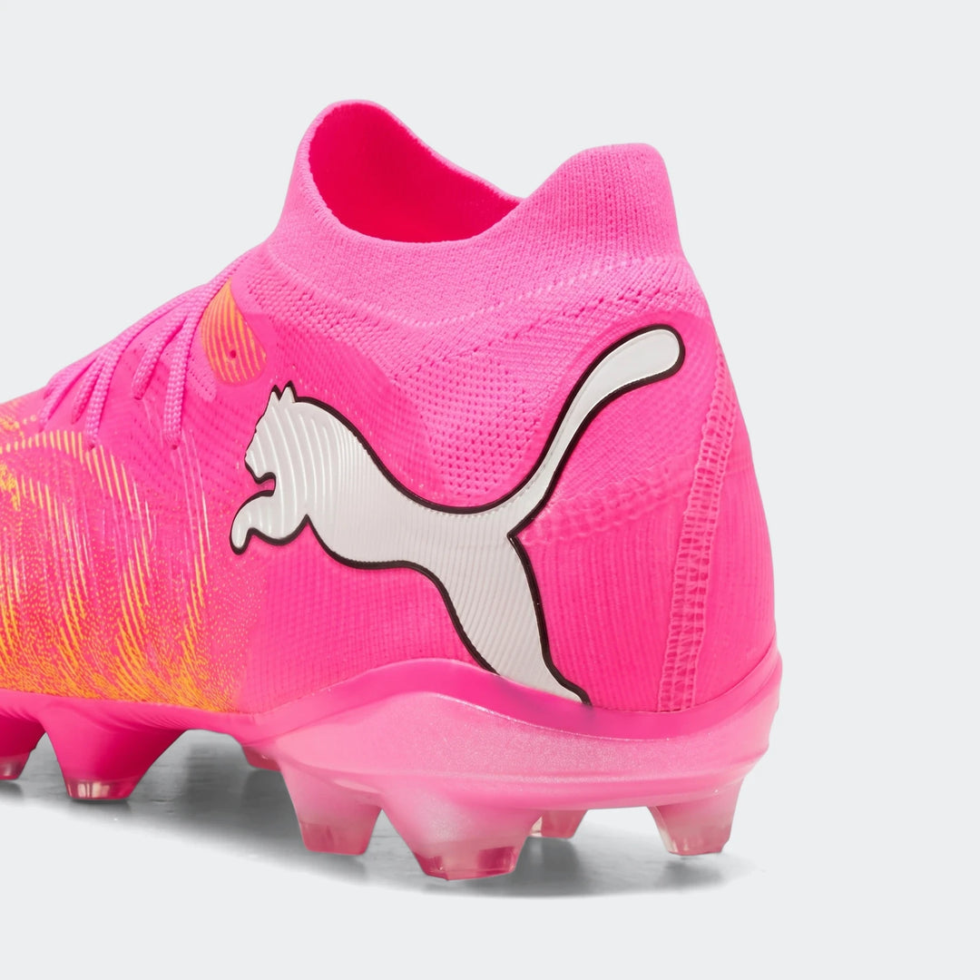 Close-up of a pink Puma Future 9 Match FG/AG Unisex football boot, featuring a white Puma logo on the heel and orange