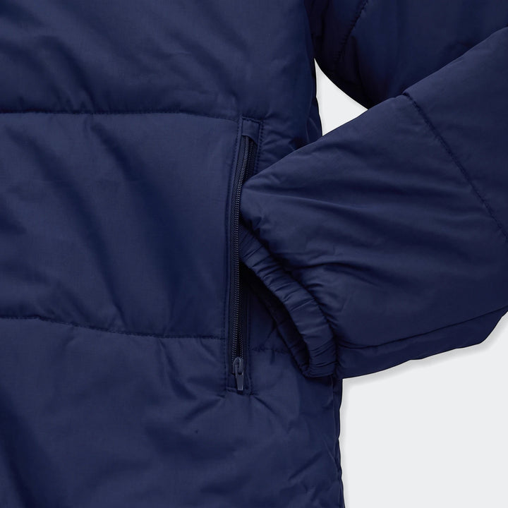 Close-up of a Puma Men's Bench Jacket in navy blue, showcasing the padded design, zippered side pocket, and elasticated