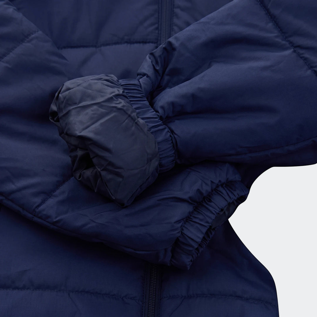 Close-up of a Puma Men's Bench Jacket in navy blue, showcasing the quilted texture and elastic cuffs on the sleeve.