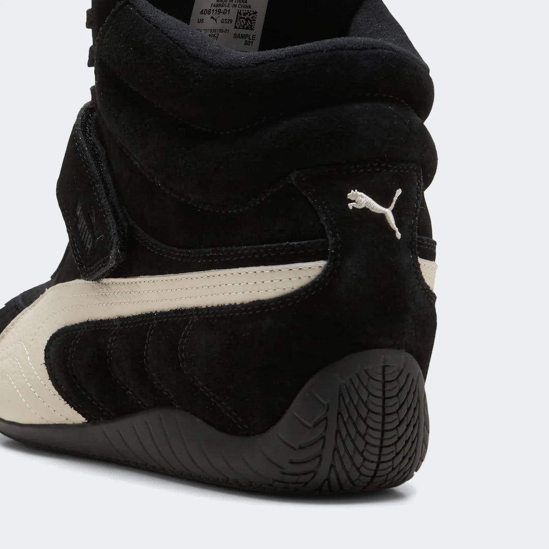 Close-up view of a black and off-white Puma Speedcat Wedge OG high-top women's sneaker made of suede and leather.