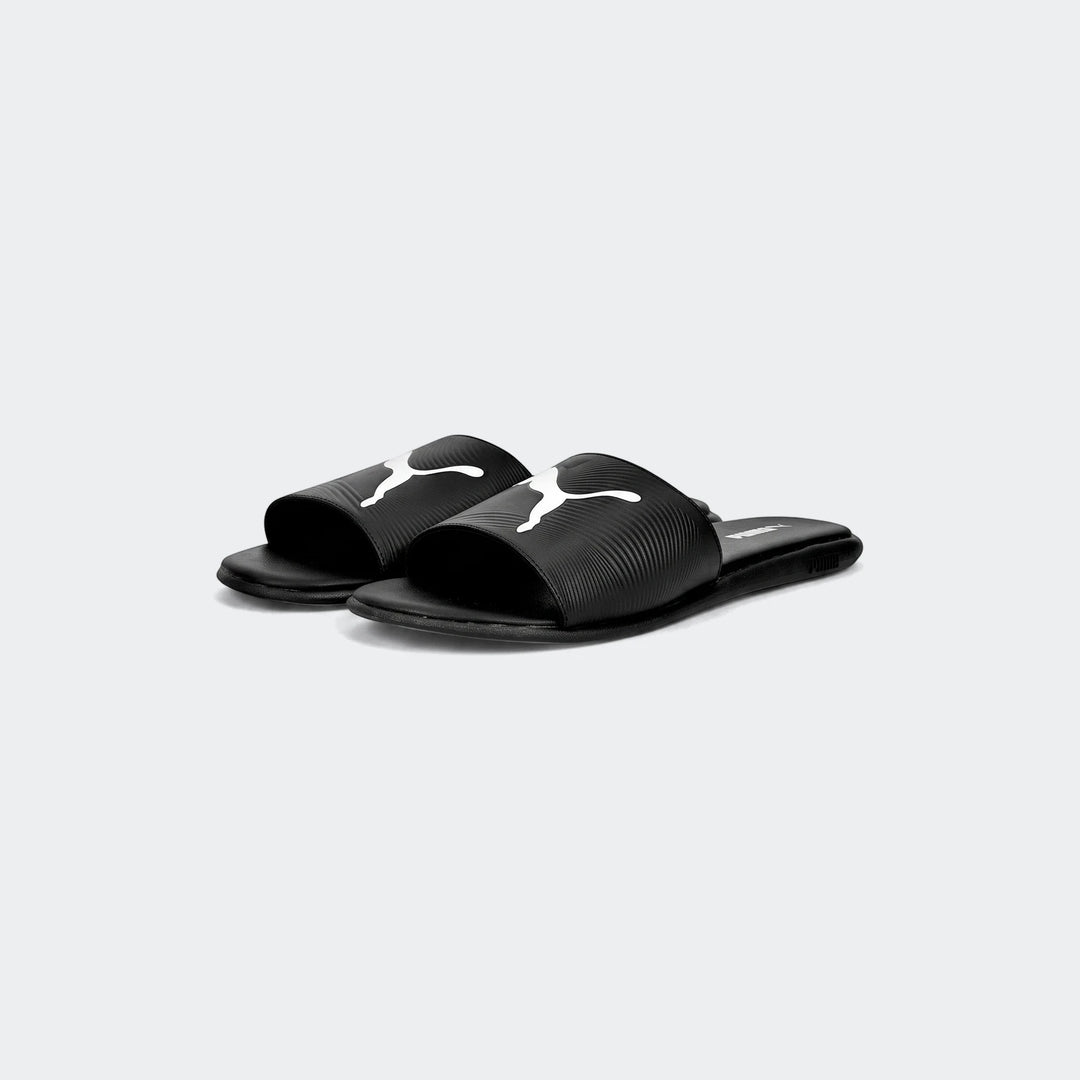 Black Puma Sporty Embossed 2.0 slides with white logo, shown from a slightly elevated side view.