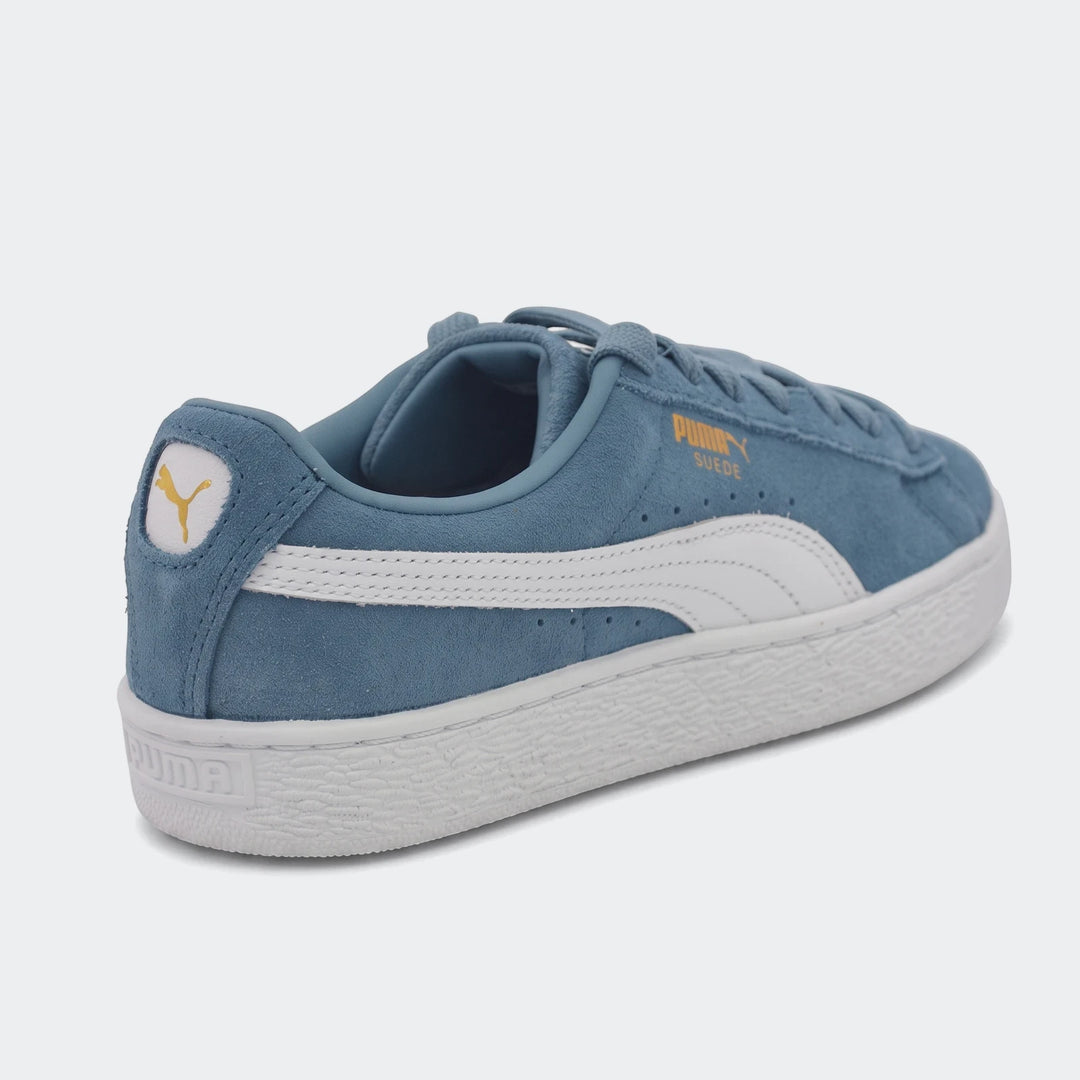 Puma Suede Classic blue low-top sneakers, crafted from soft suede with white side stripes and a chunky white sole, shown