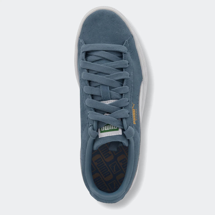 Puma Suede Classic blue sneaker, made of suede, featuring white soles and blue laces, shown from a top-down view.