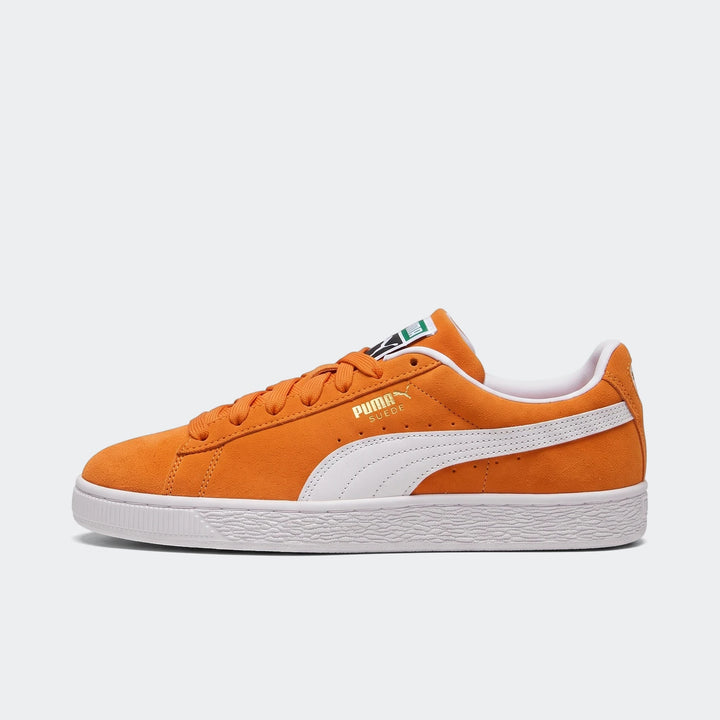 Side view of unisex Puma Suede Classic sneakers in cayenne pepper orange with white formstrip and rubber sole.