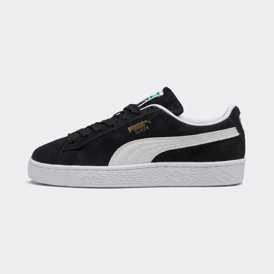 Black Puma Suede Classic sneakers for youth, side view, with white laces and a textured white sole.