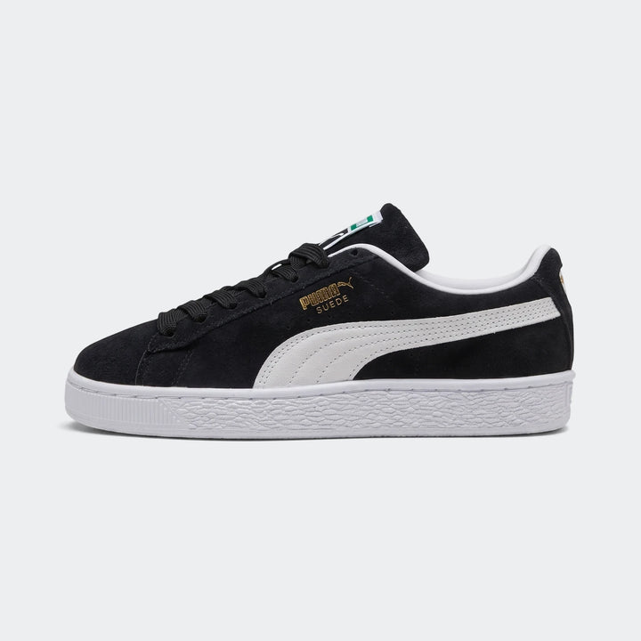 Black Puma Suede Classic sneakers for youth, side view, with white laces and a textured white sole.