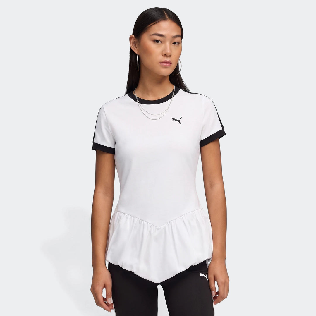 Woman models a white Puma T7 Balloon Crew Neck Short Sleeve T-Shirt with black trim and a peplum hem.