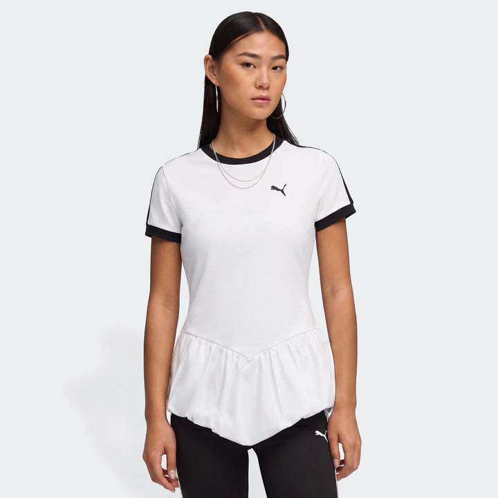 Woman models a white Puma T7 Balloon Crew Neck Short Sleeve T-Shirt with black trim and a peplum hem.