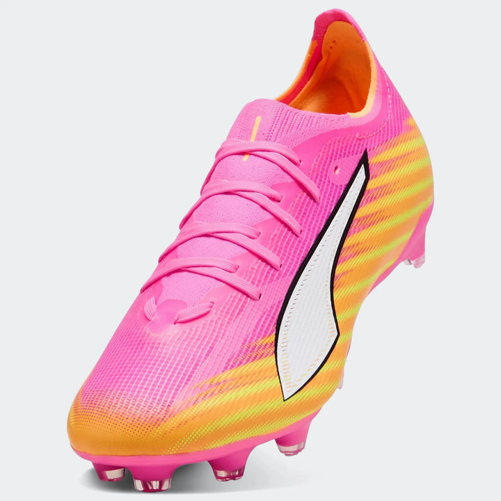 Puma Ultra 6 Match Fg/Ag football boots in vibrant pink and orange with a striking striped design and white logo.