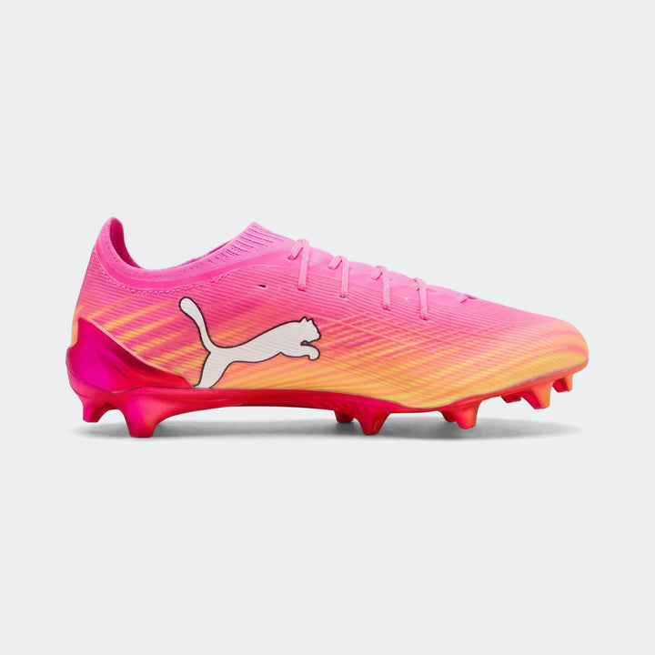 Unisex Puma Ultra 6 Ultimate FG football boots in vibrant pink and yellow with visible studs, shown from a side profile.