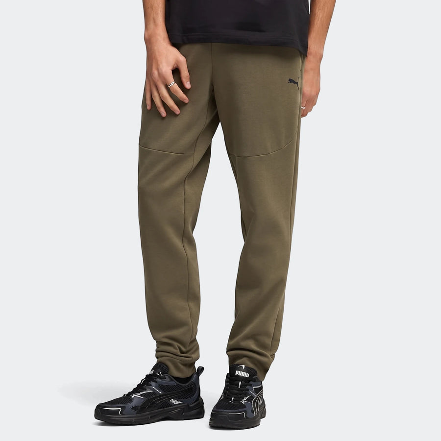 Pumatech Loden Green Track Pants on a male model, showcasing the comfortable fit of the olive green joggers and black