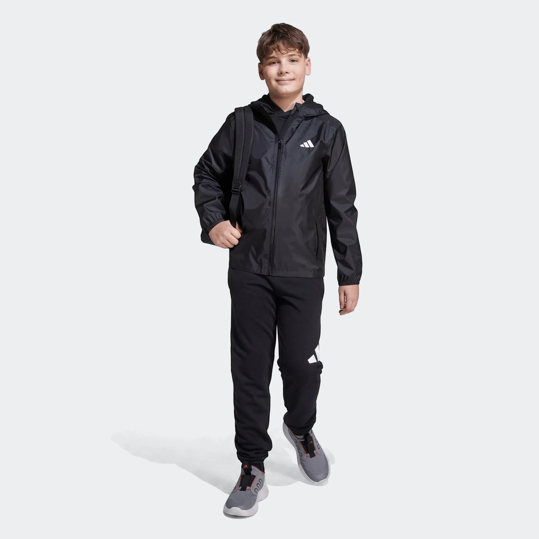 Rain Jacket Kids in black with hood and full zip front, lightweight shell shown in front view.
