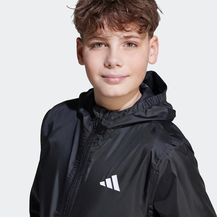 Rain Jacket Kids in black with hood and front zipper, close-up front view showing lightweight rain shell fabric.