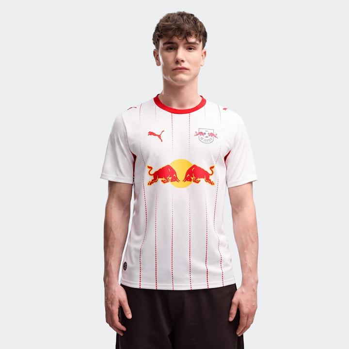 Men's Rb Leipzig 26/27 Home Jersey, white with red trim, Puma and Red Bull logos, modeled by a young man facing forward.