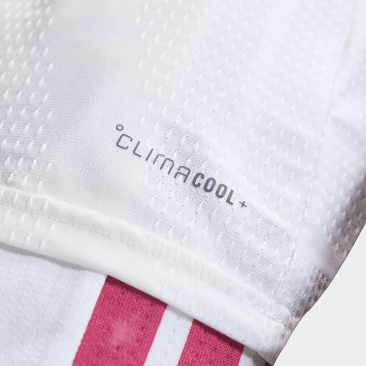 Close-up of Real Madrid 25/26 Authentic Home Jersey showing white fabric with CLIMACOOL+ logo and pink stripe detail.