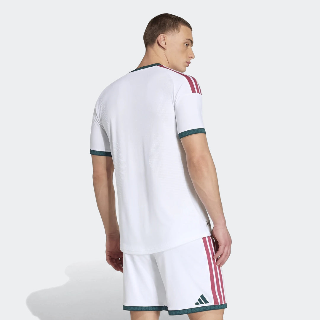 Men's white Real Madrid 25/26 Authentic Home Jersey and shorts, rear view. Features burgundy stripes and green trim.