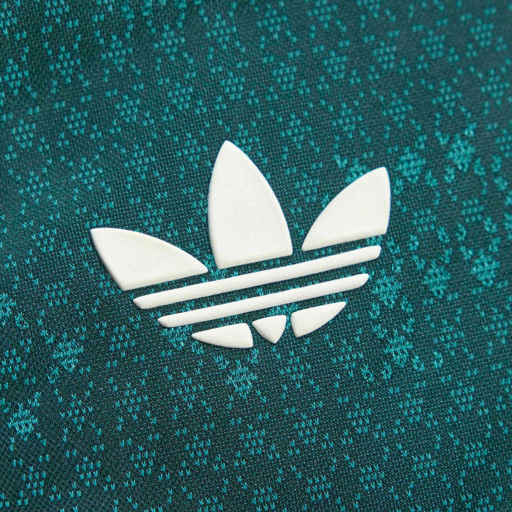 Close-up of a Real Madrid 26/27 Away Authentic Jersey, featuring a white Adidas Trefoil logo on teal knit fabric.