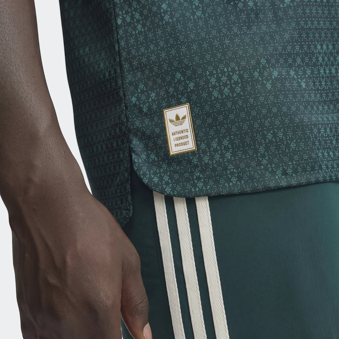 Close-up of a dark green patterned Real Madrid 26/27 Away Authentic Jersey and matching shorts with three white stripes worn