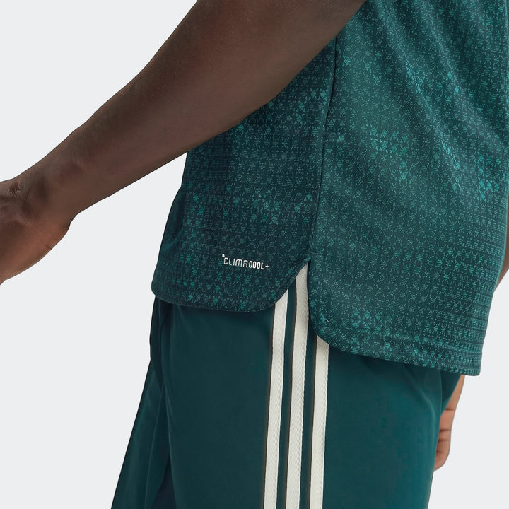 Dark green Real Madrid 26/27 Away Authentic Jersey worn by a person, showcasing the textured fabric and white side stripes.