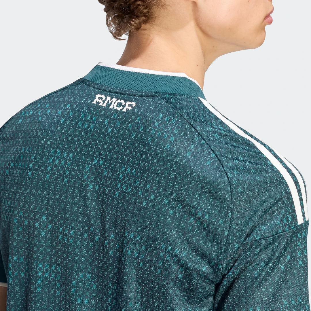 Real Madrid 26/27 Away Authentic Jersey, featuring a green and teal pattern, RMCF logo, and white Adidas stripes on the back.