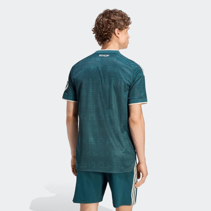 Rear view of a male model wearing the dark teal Real Madrid 26/27 Away Authentic Jersey and matching shorts.