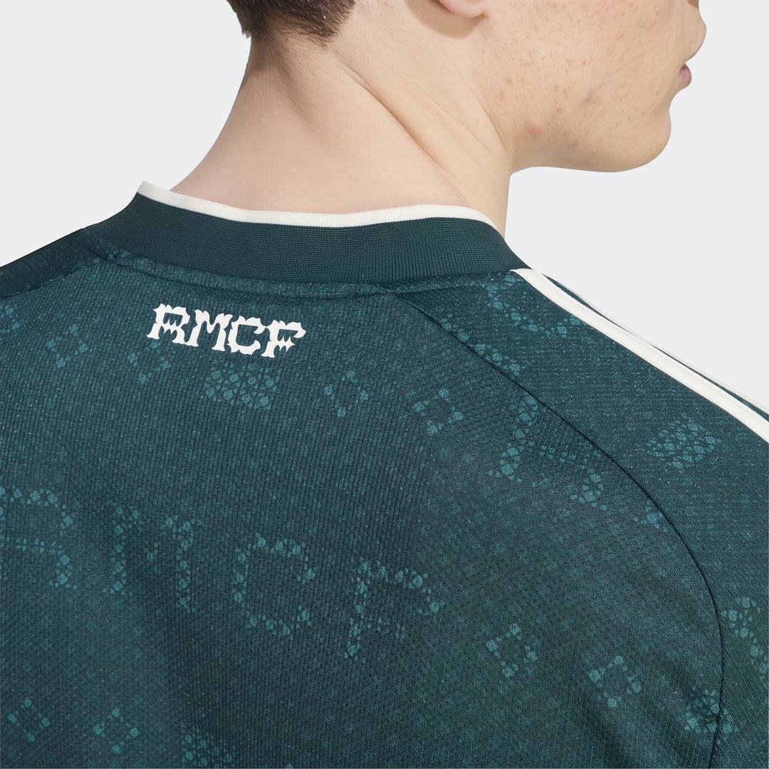 Close-up back view of a male model wearing a dark green Real Madrid 26/27 Away Jersey with a subtle patterned texture and