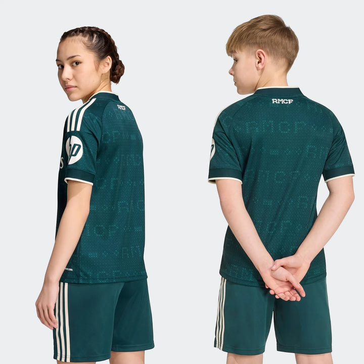Real Madrid 26/27 Away Jersey Kids, dark green kit with white stripes, modeled by a boy and a girl on a white background.