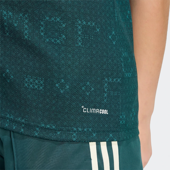 Kids' dark teal Real Madrid 26/27 Away Jersey with subtle pattern and white 'CLIMACOOL' logo, worn with matching shorts.