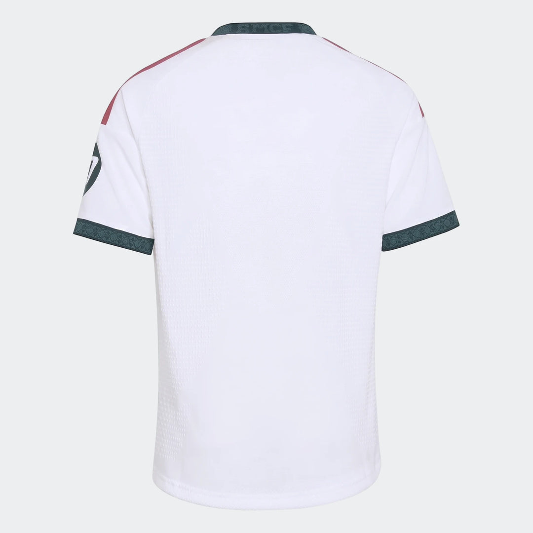 Real Madrid 26/27 Home Jersey for Kids, white, short-sleeved, featuring dark green trim and maroon shoulder accents, shown