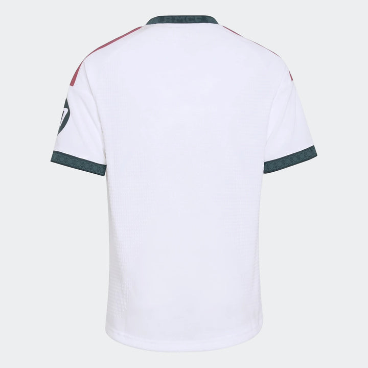 Real Madrid 26/27 Home Jersey for Kids, white, short-sleeved, featuring dark green trim and maroon shoulder accents, shown