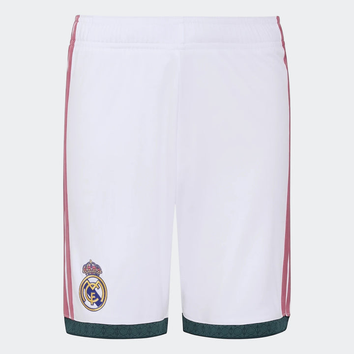 White Real Madrid 26/27 Home Kids Shorts in a flat lay view, featuring pink side stripes and the club crest.